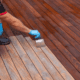 Professional worker staining a deck at Ponderosa Painting.