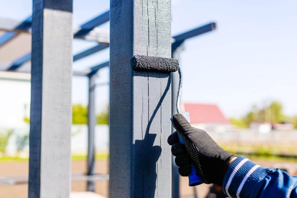 painting-a-gray-wooden-structure-outside